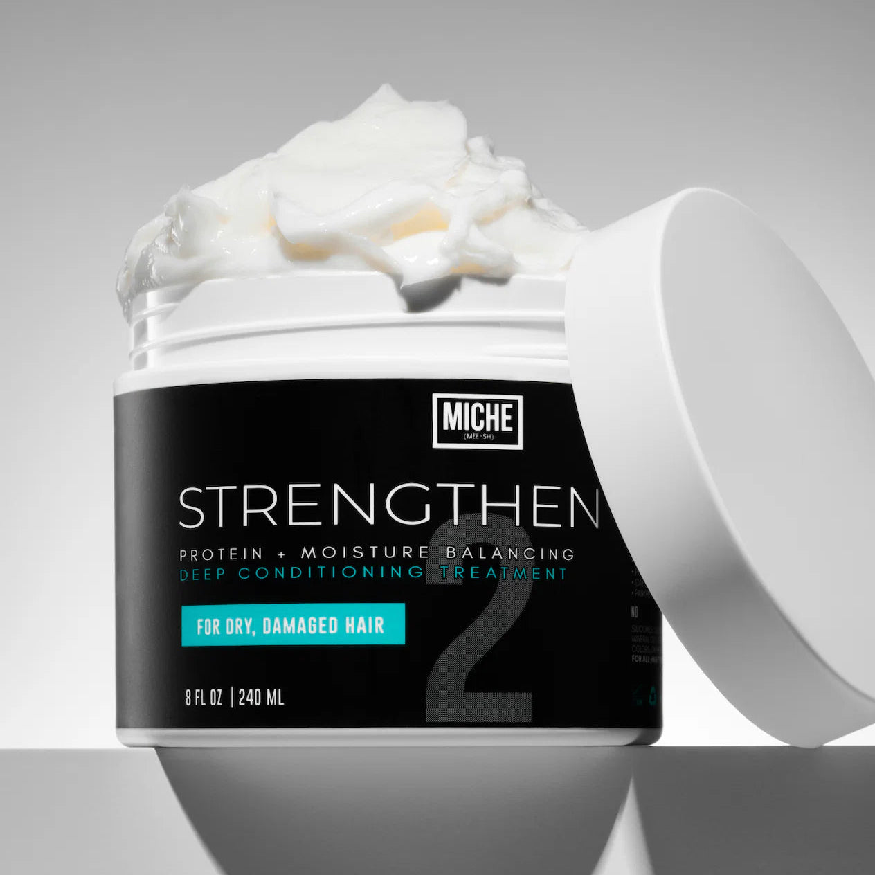 Miche hair treatment strengthen jar with white cream on a gray background