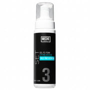 Miche styling mousse bottle on a gray background
