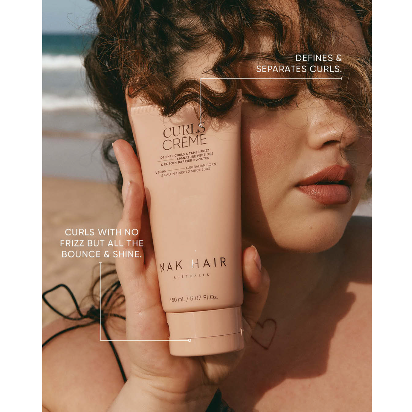 Woman holding NAK Hair Curls Crème 150ml, a vegan styling cream formulated to define and separate curls while controlling frizz and adding bounce and shine