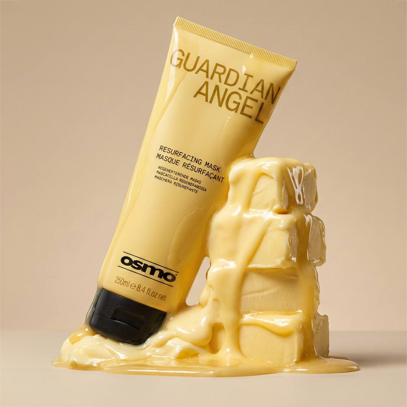 OSMO Guardian Angel Resurfacing Mask 250ml gold tube displayed beside a rich, creamy hair-mask texture to highlight its nourishing formula.