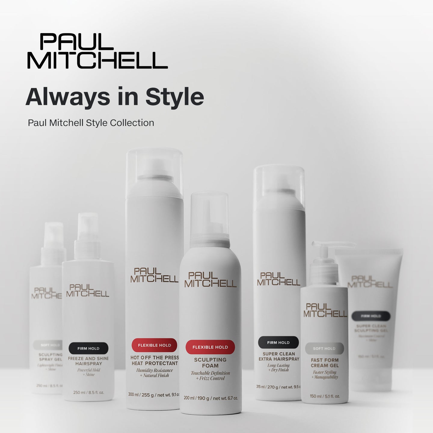 Paul Mitchell styling collection in white bottles on a softly lit grey background, featuring products for soft, flexible and firm hold.