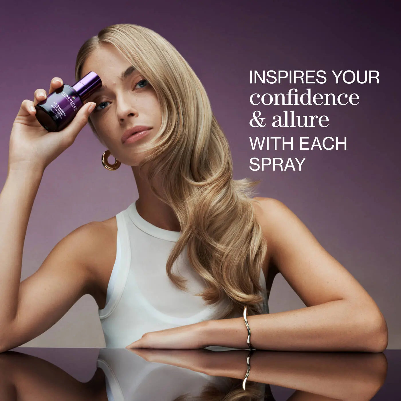 Model with glossy styled hair holding Pureology Love Luster Hydrating Hair Perfume 50ml for soft, shiny and beautifully scented hair