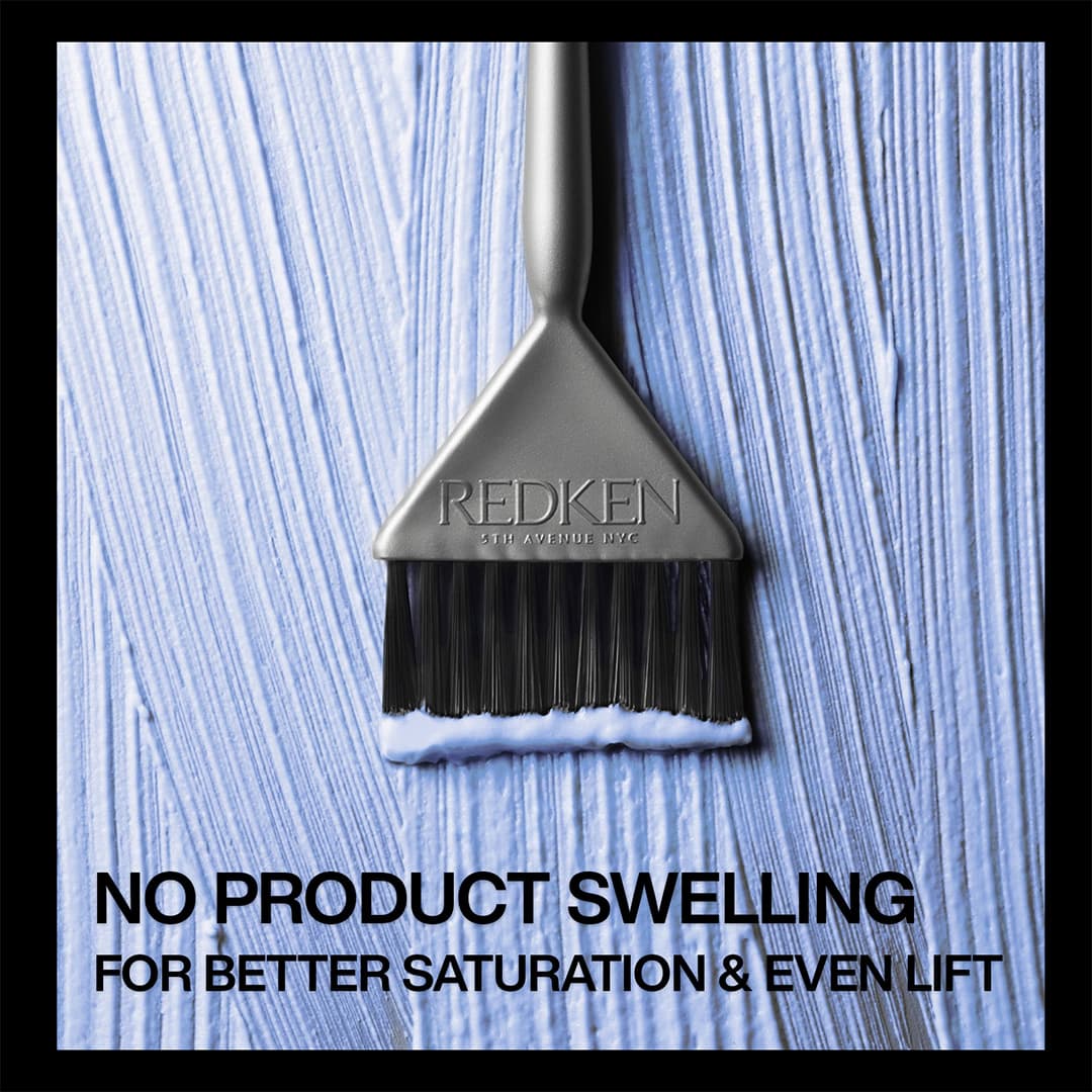 Blue Redken BlondiQ 9+ lightener mixture spread with a tint brush, showing a smooth, non-swelling texture for even saturation and lift