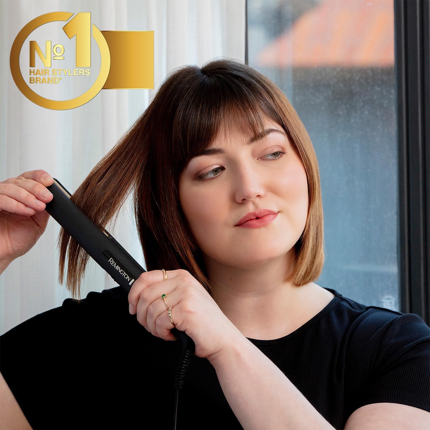 Woman styling short hair with the Remington Ceramic Slim 220 Hair Straightener for smooth, sleek and shiny results.