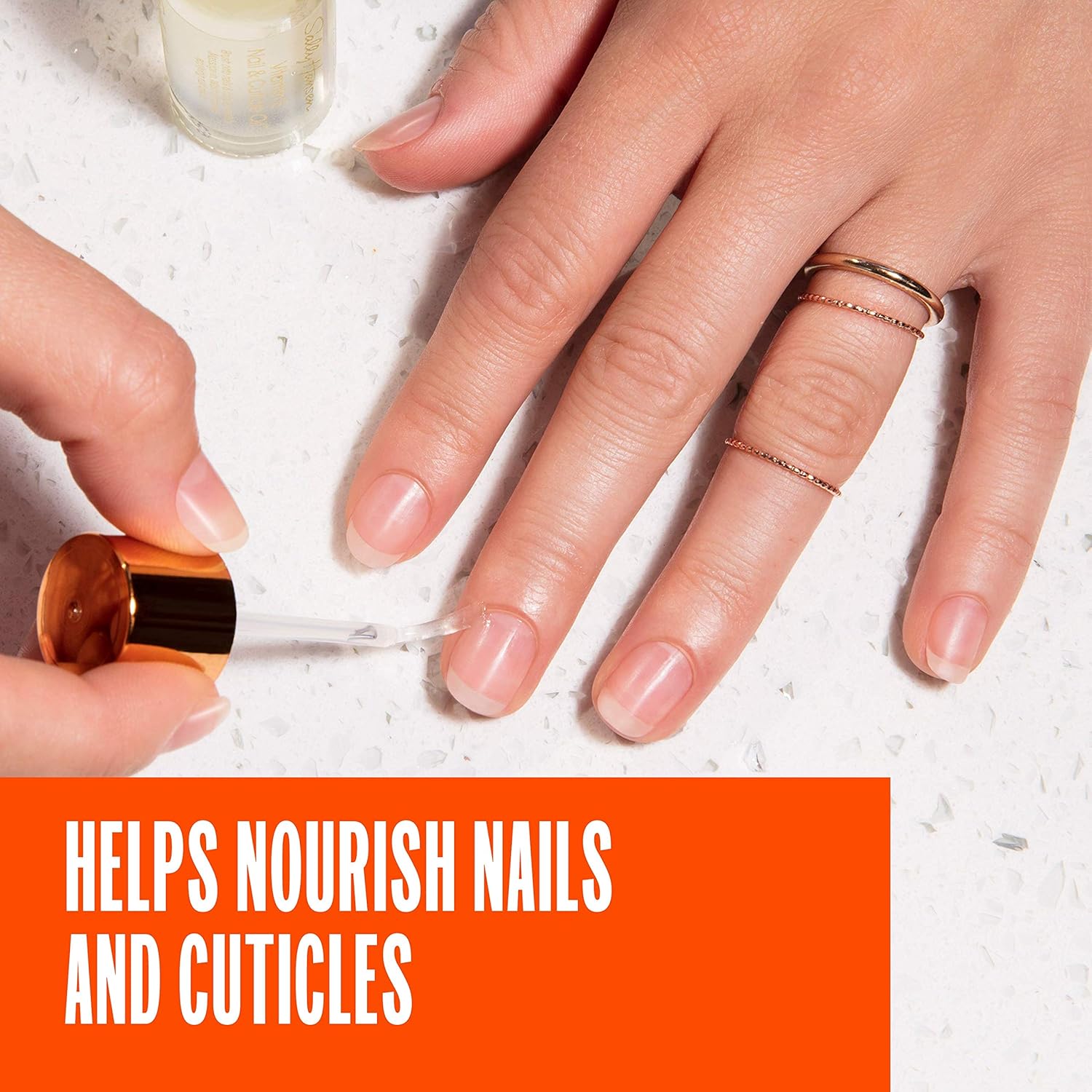 Sally Hansen Vitamin E Nail & Cuticle Oil 13.3ml on white hand application and writing
