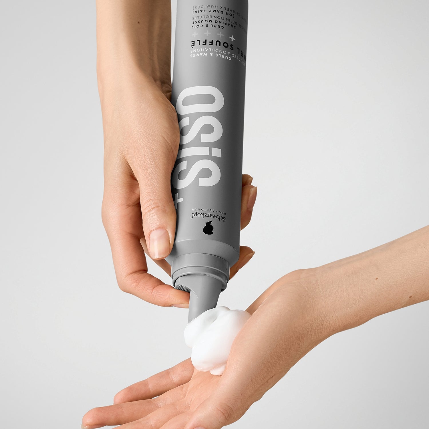Hand using Schwarzkopf Professional Osis Curl Souffle Shaping Mousse 200ml