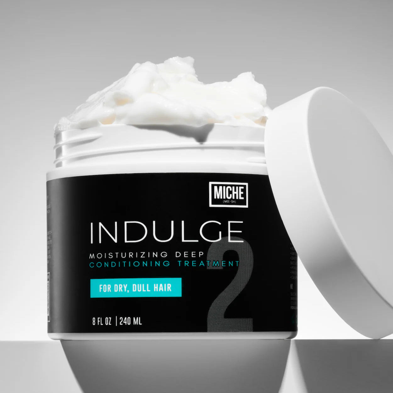 Miche Indulge moisturizing deep conditioning treatment jar with open lid on a gray background