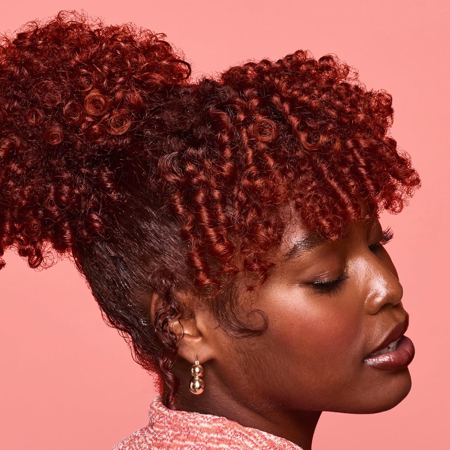 Close-up of smooth, shiny and defined natural curls styled with SheaMoisture Coconut & Hibiscus + Flaxseed Define & Shine Styling Gel