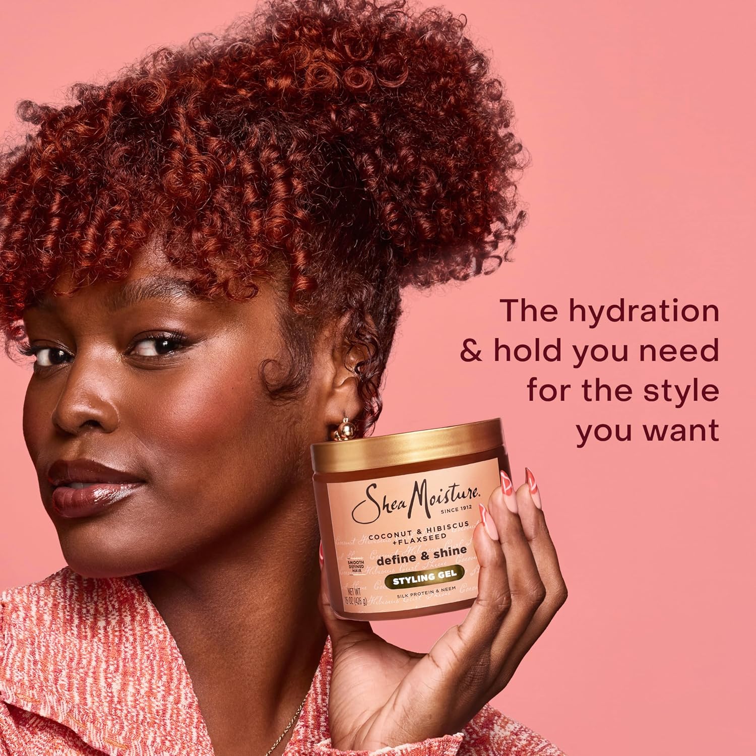 Woman holding SheaMoisture Coconut & Hibiscus + Flaxseed Define & Shine Styling Gel 15oz / 425g for hydrating hold, curl definition and brilliant shine