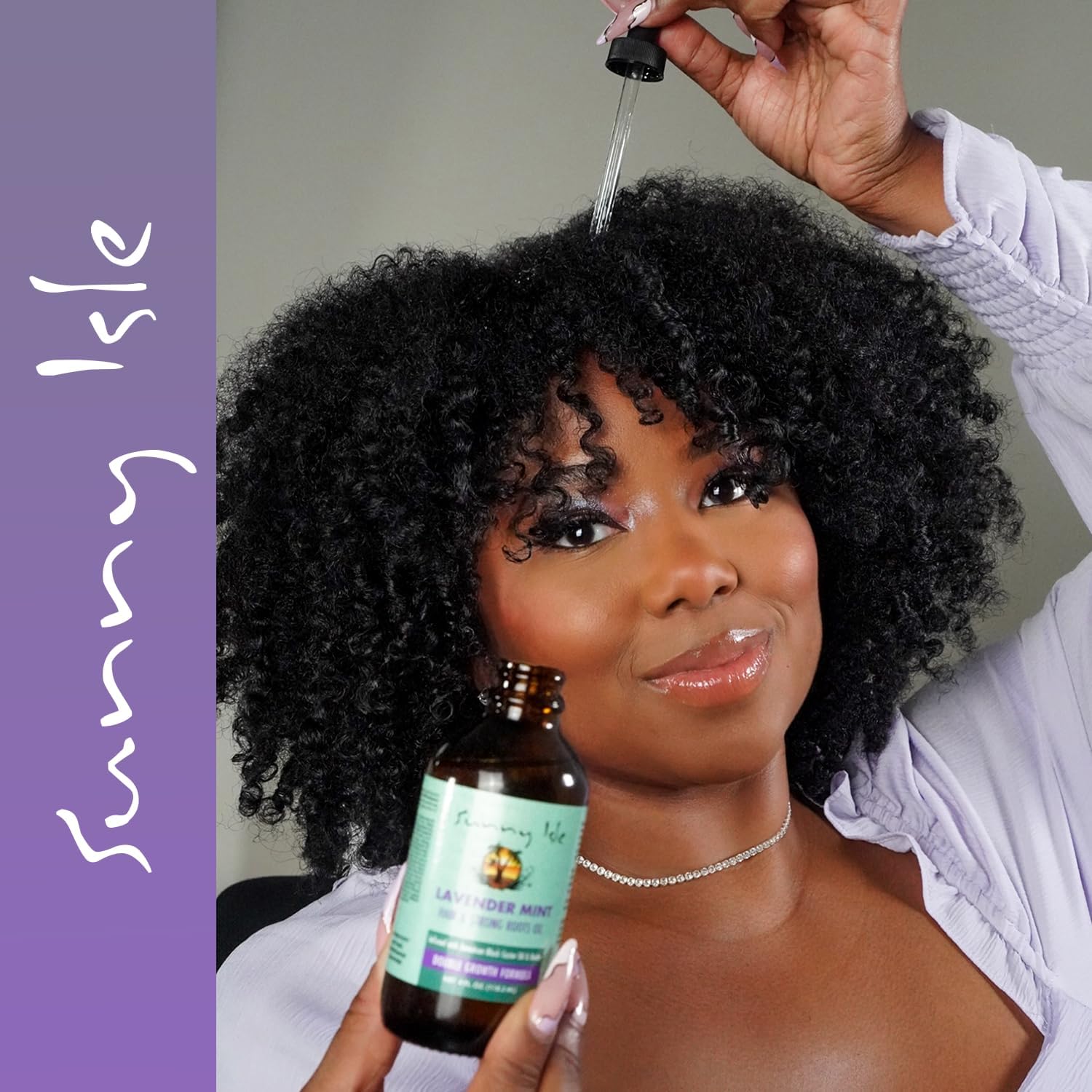 Woman applying Sunny Isle Lavender Mint Hair & Strong Roots Oil to her scalp with a dropper to nourish roots, hydrate the scalp, and support healthy hair growth.