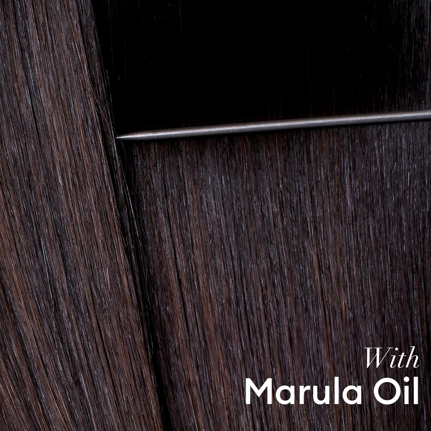 Smooth, glossy dark hair finished with TRESemmé Keratin Smooth Finishing Oil with marula oil