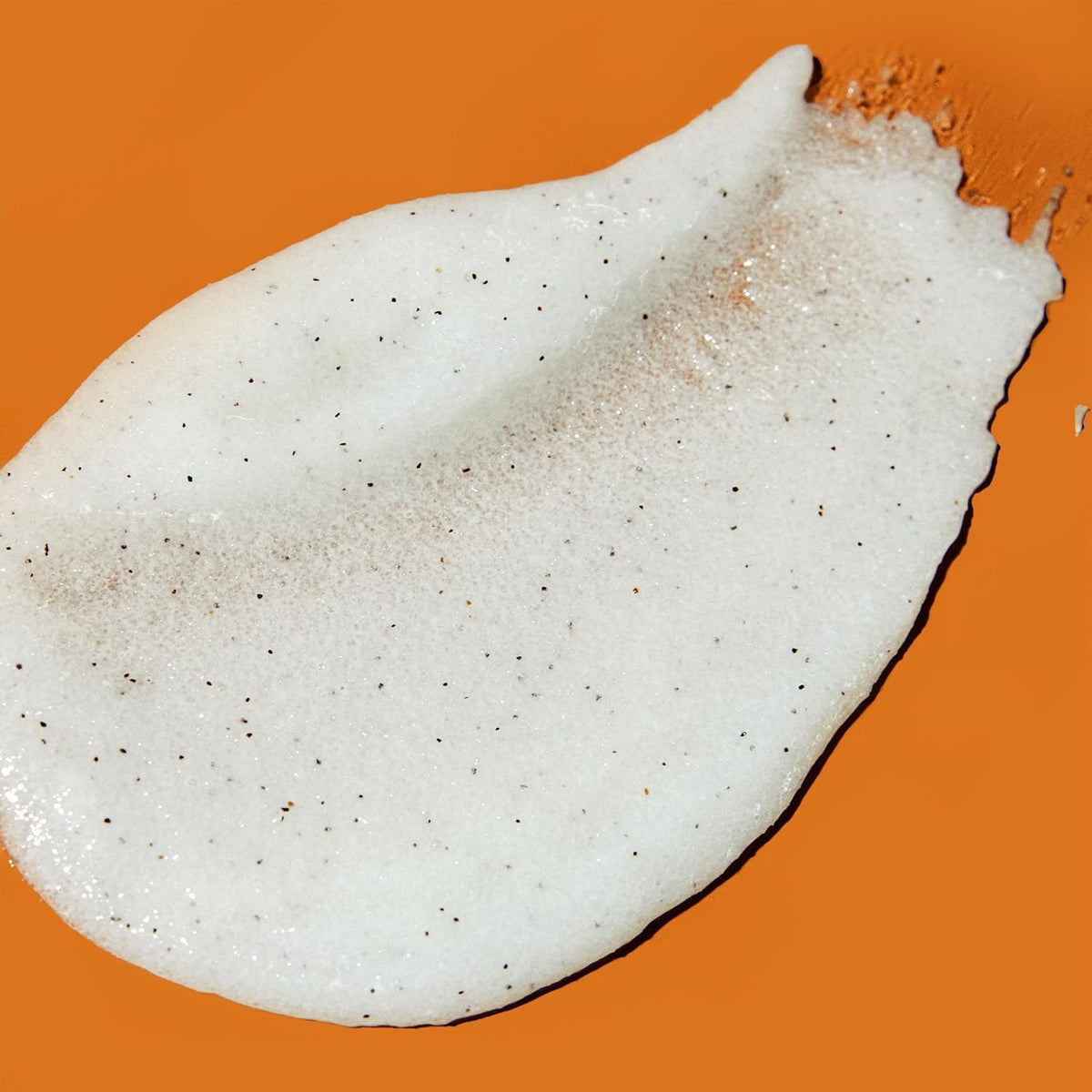 a visual texture example of Tree Hut Coco Colada Shea Sugar Scrub 18oz on a solid orange background