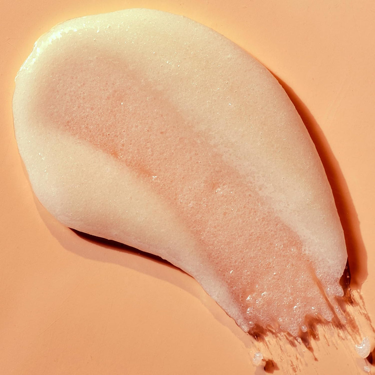a visual texture example of Tree Hut Vanilla Shea Sugar Scrub 18oz on a peach background
