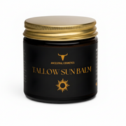 Black jar of Tallow Sun Balm with gold lid on a beige background