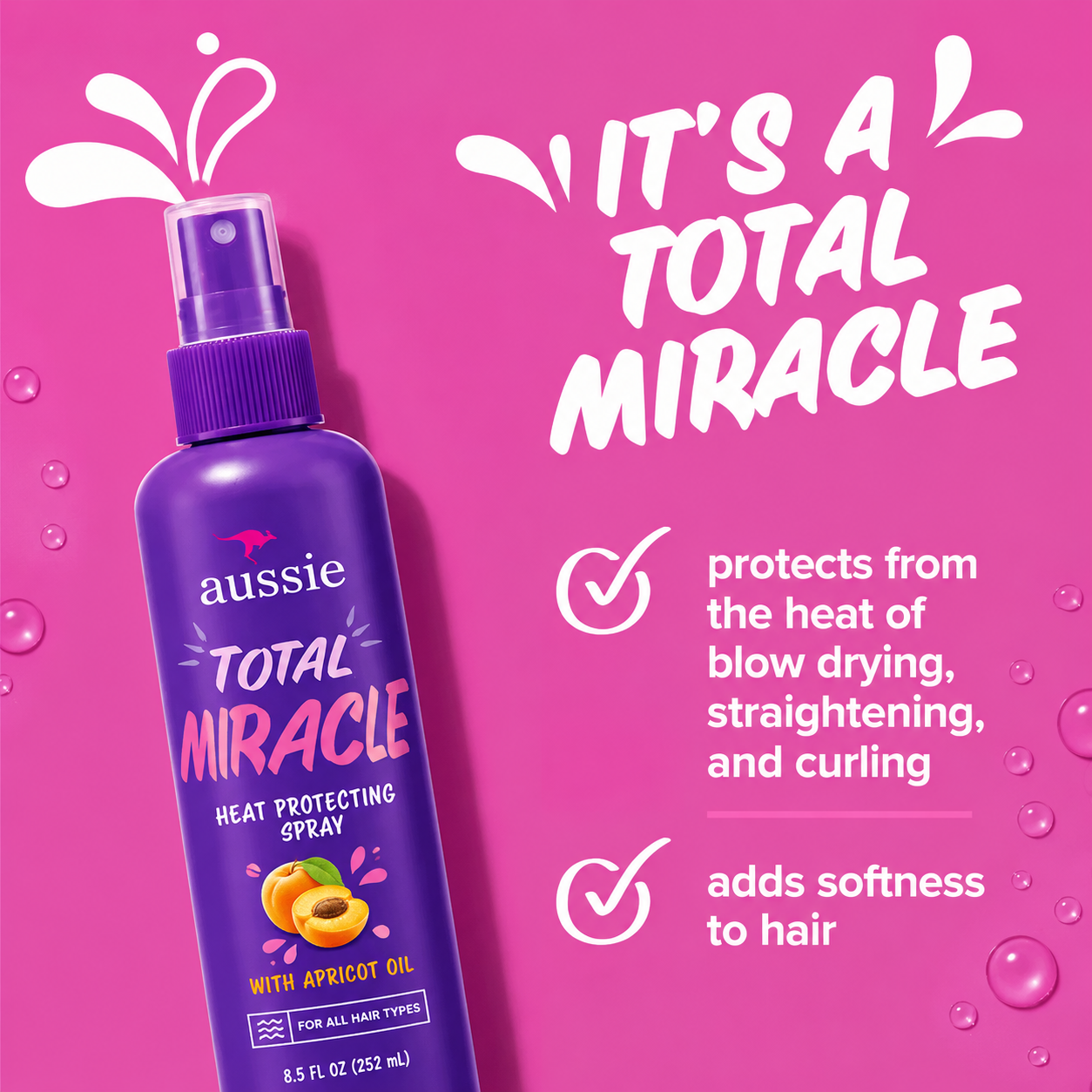 a promotional graphic featuring aussie total miracle heat protecting spray in a purple spray bottle against a bright pink background. bold white text reads "it's a total miracle", highlighting protection from the heat of blow drying, straightening, and curling, while helping leave hair soft and smooth.