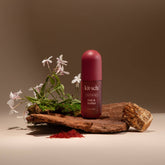 Kitsch bottle of Oak & Amber on a wooden platform with flowers and natural elements