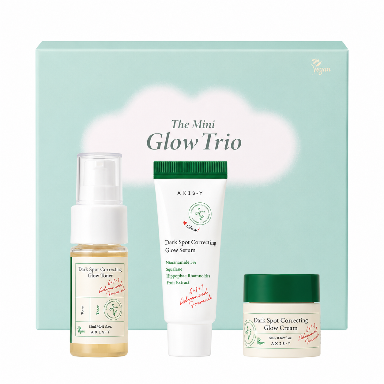 axis-y the mini glow trio skincare gift set featuring travel-size dark spot correcting glow toner, glow serum and glow cream in front of a pastel green gift box. brightening skincare set formulated with niacinamide, squalane and sea buckthorn fruit extract to hydrate skin and help improve the appearance of dark spots and uneven skin tone.