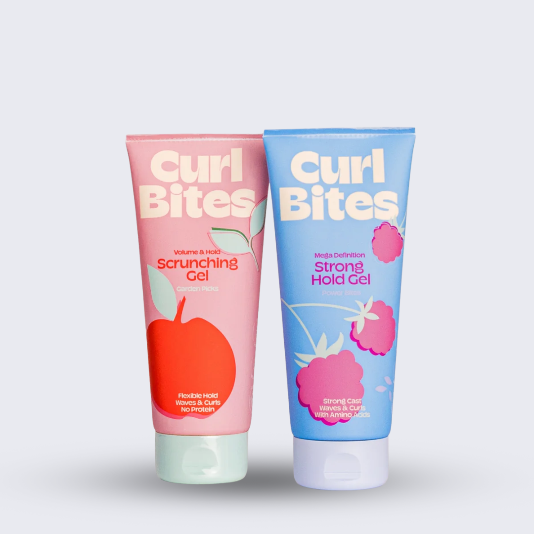 Two tubes of Curl Bites scrunching and mega defintion gel, one pink and one blue, on a white background.