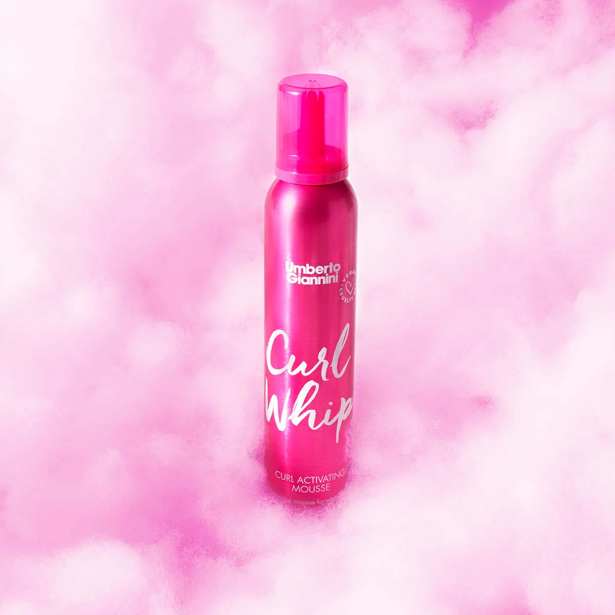 Umberto Giannini Curl Whip Mousse in pink cloud background