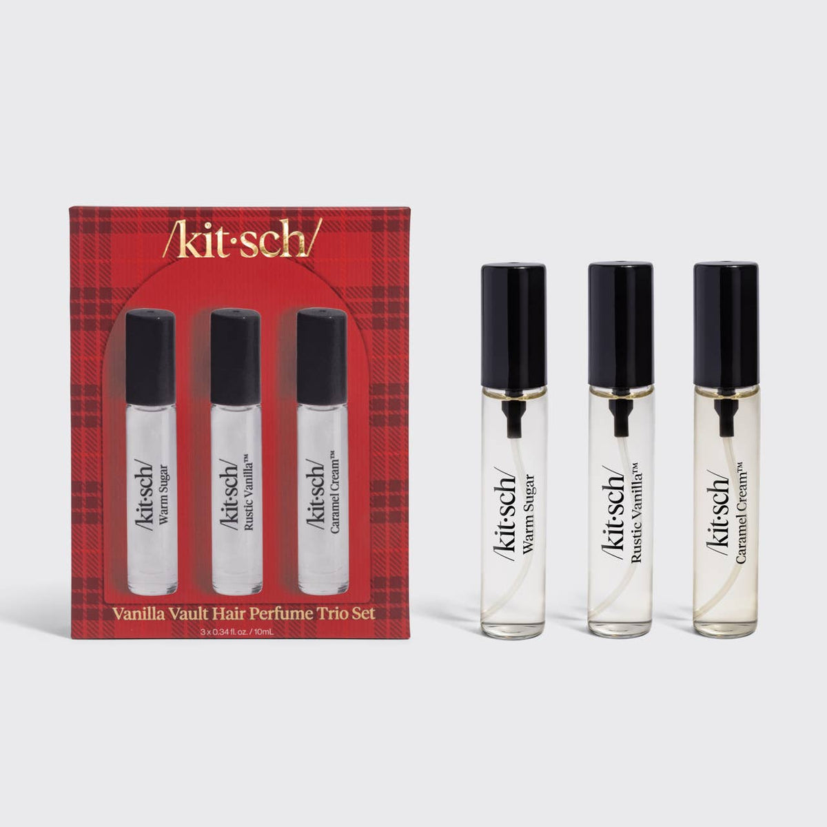 Kitsch Vanilla Vault Hair Perfume Trio Set, featuring a red plaid box containing three small glass vials, with three additional clear glass rollerball vials displayed beside it on a light gray background.