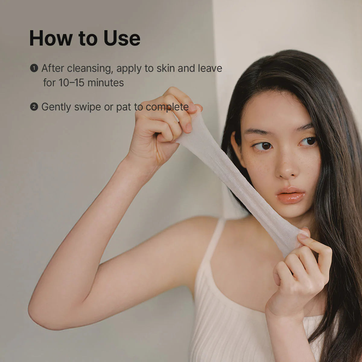dr. althea stretchfit calming pad how-to-use guide showing a model stretching a toner pad before application. demonstrates applying the pad to clean skin for 10–15 minutes, then gently swiping or patting the remaining essence into the skin after removal.