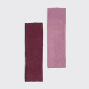 Two rectangular Kitsch ribbed fabric accessories, one in deep burgundy and one in dusty pink, displayed vertically side-by-side on a light gray background.