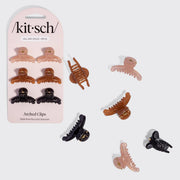 Kitsch Arched Clips set of 8 all-day hold hair clips in assorted colors, shown both on the pink retail card packaging and scattered individually on a light gray background.