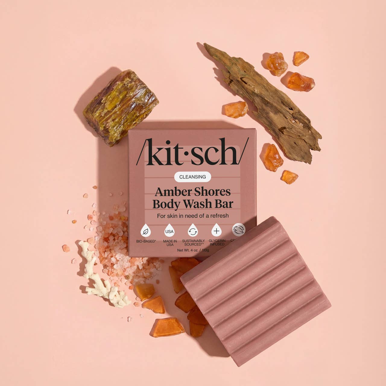 Kitsch Amber Shores body wash bar with packaging on a pink background