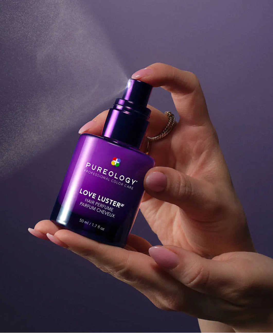 Hand spraying Pureology Love Luster Hydrating Hair Perfume 50ml lightweight hair mist for hydration, freshness and shine