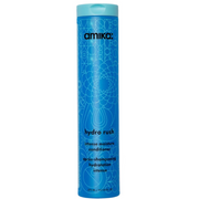 A tall, slender blue bottle of Amika Hydro Rush Intense Moisture Conditioner with a geometric pattern design.