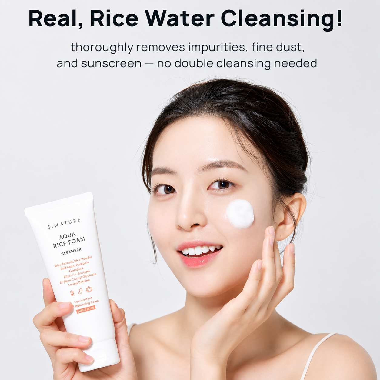 model holding s.nature aqua rice foam cleanser with cleanser applied to her cheek, highlighting rice water cleansing for removing impurities, fine dust, and sunscreen.