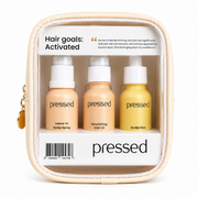 pressed hair care travel kit with leave-in scalp spray, nourishing hair oil and scalp elixir in a clear zip pouch on a white background