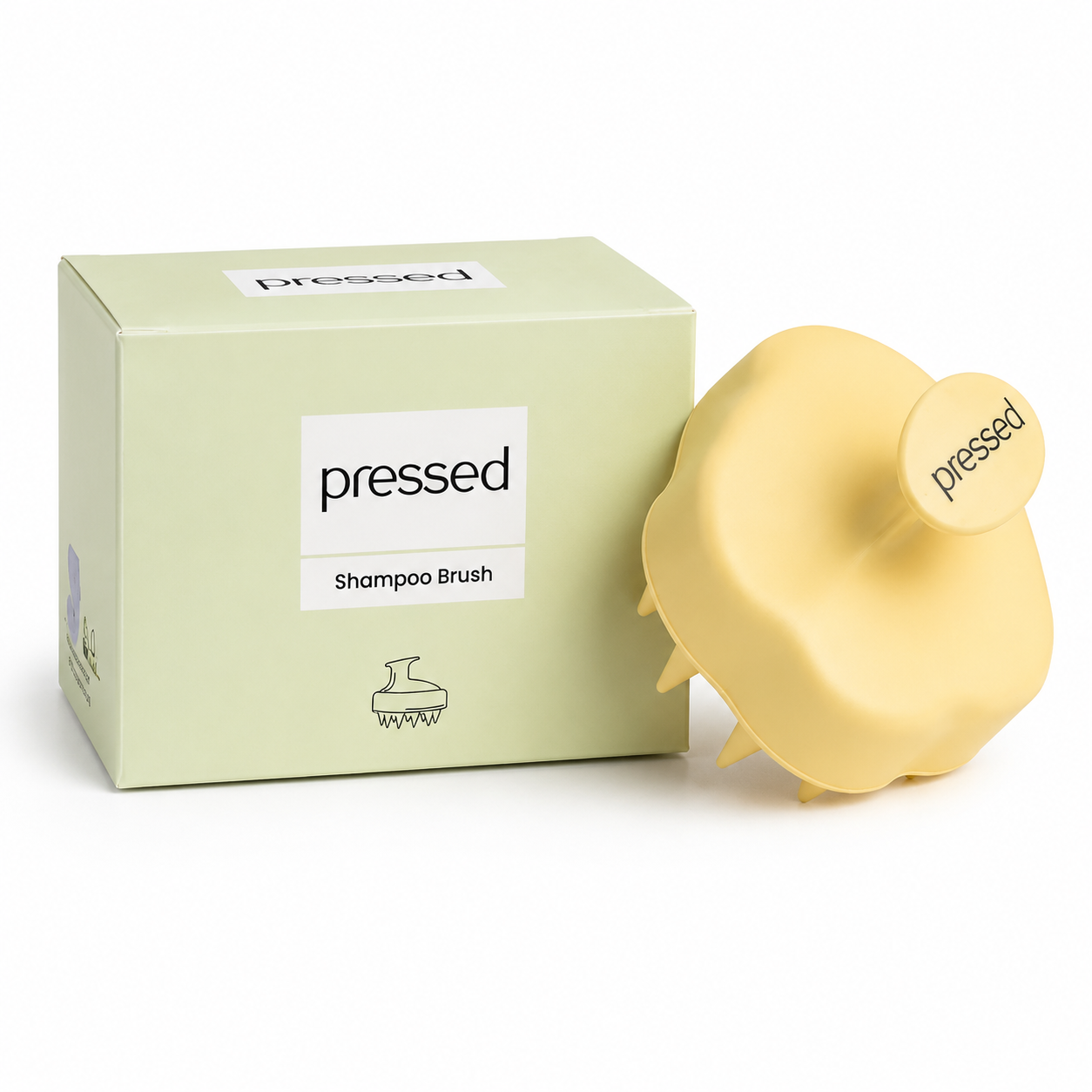pressed shampoo brush with pale yellow silicone scalp massager and matching light green retail box displayed on a white background.