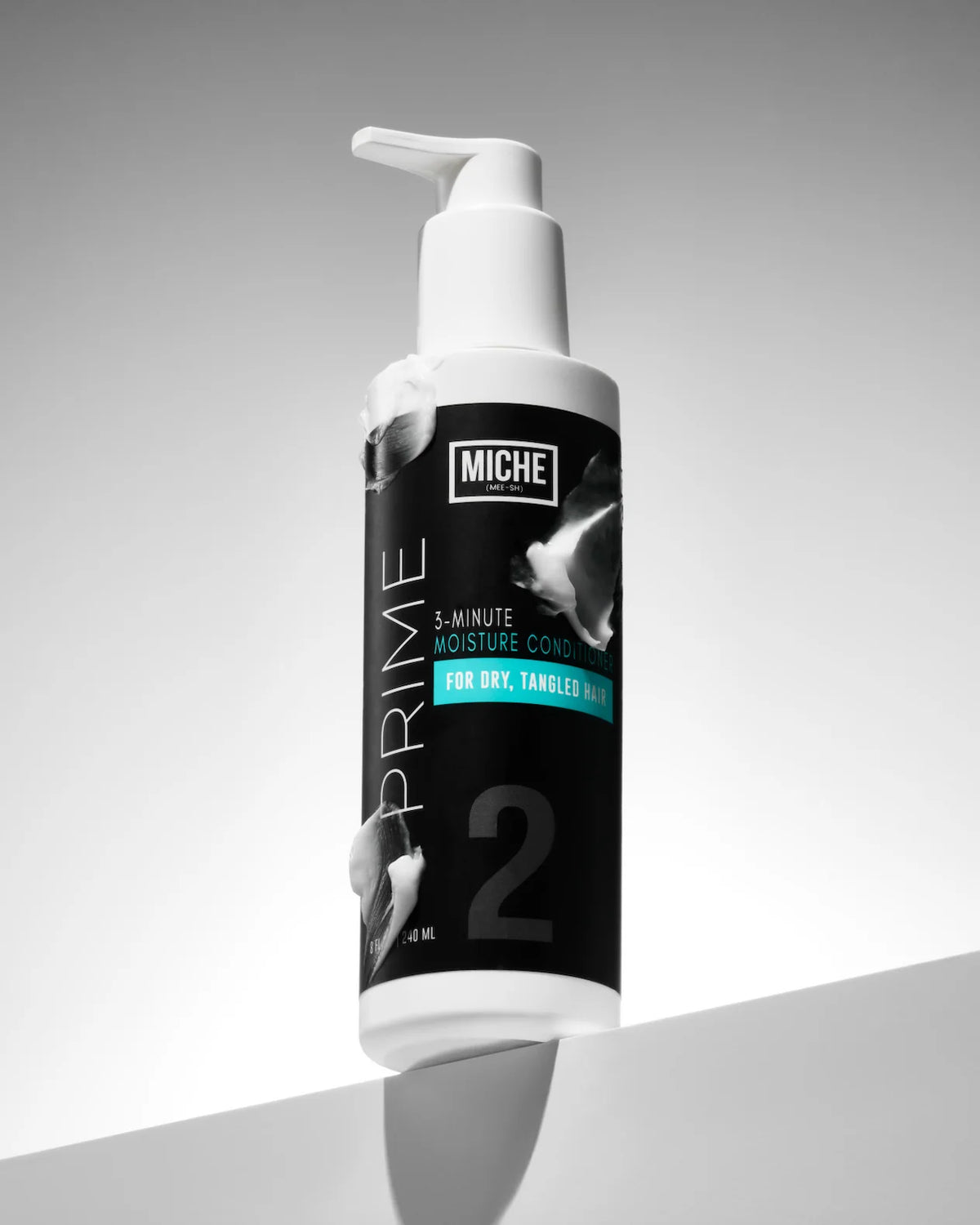 A bottle of MICHE PRIME 2 5-Minute Moisture Conditioner for dry, tameless hair, featuring a black and white label with a white pump dispenser, set against a clean gray background.