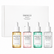 skin1004 madagascar centella ampoule kit featuring four serums in a white presentation box. skincare gift set includes the original centella ampoule, poremizing fresh ampoule, tea-trica relief ampoule and tone brightening capsule ampoule to help soothe, hydrate, refine pores and brighten the complexion.