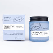 A product image showing UpCircle Shampoo Crème with Coconut + Grapefruit Oil in a blue jar with a black lid, alongside its packaging box.