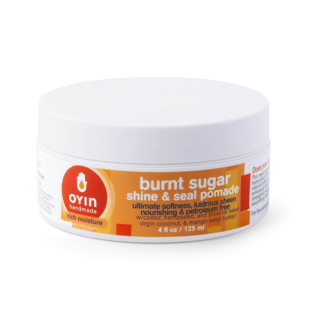 A white jar with a label that reads 'Oyin Handmade Burnt Sugar Shine & Seal Pomade'. The jar is closed and there is no visible product in front of it.